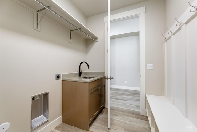 2330 E Monhegan Dr, Eagle, ID 83616 - clothes washing area with hookup for an electric dryer, light wood-type flooring, cabinet space, and baseboards
