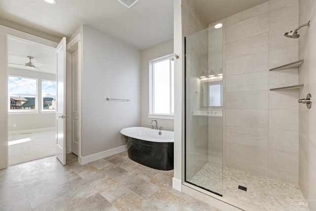 2330 E Monhegan Dr, Eagle, ID 83616 - full bath featuring tiled shower, baseboards, a freestanding bath, a ceiling fan, and recessed lighting