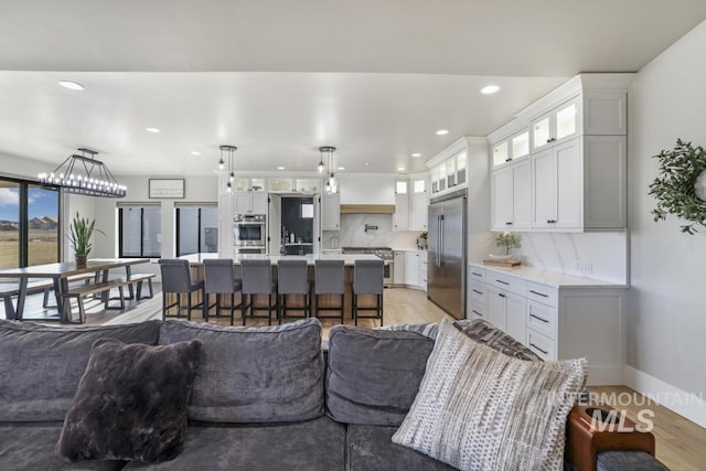 living room featuring an inviting chandelier and light wood-type flooring