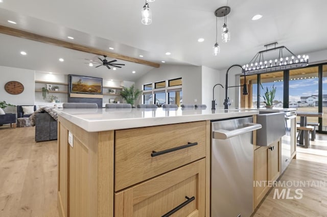 kitchen featuring decorative light fixtures, light brown cabinetry, a kitchen island with sink, light wood-type flooring, and stainless steel dishwasher