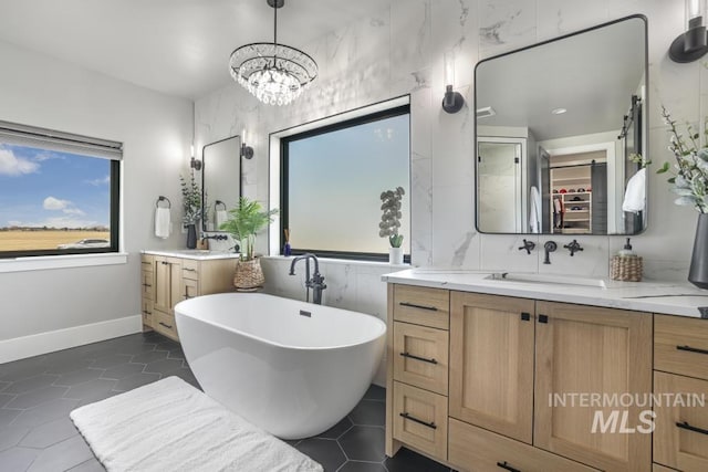 bathroom featuring a bath, tile patterned floors, and vanity