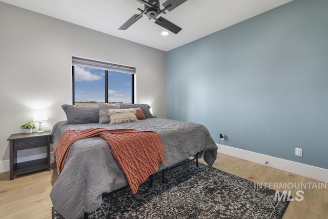 bedroom with light hardwood / wood-style flooring and ceiling fan