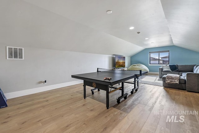 playroom featuring light hardwood / wood-style flooring and lofted ceiling