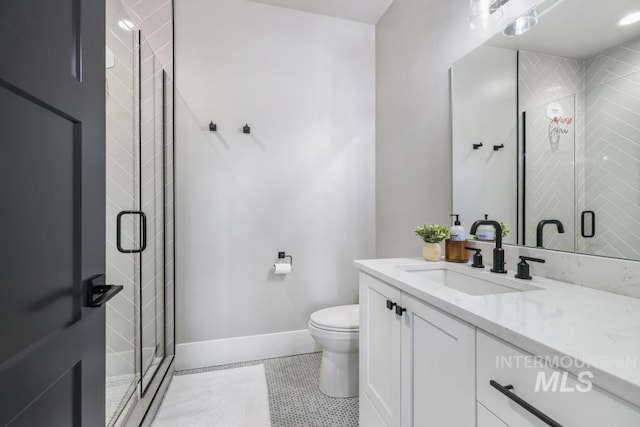 bathroom with toilet, tile patterned flooring, walk in shower, and vanity