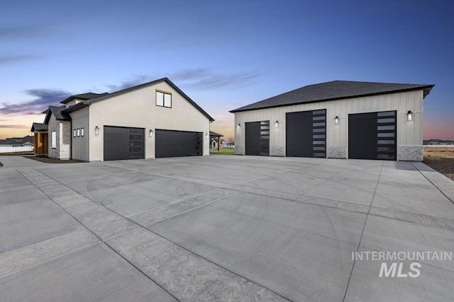 view of garage at dusk