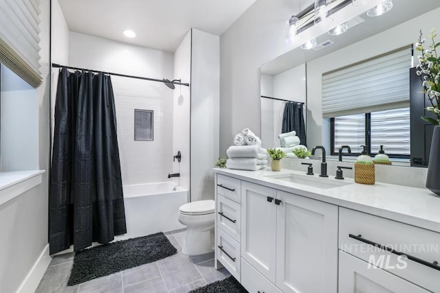 full bathroom featuring shower / bath combo with shower curtain, toilet, and vanity