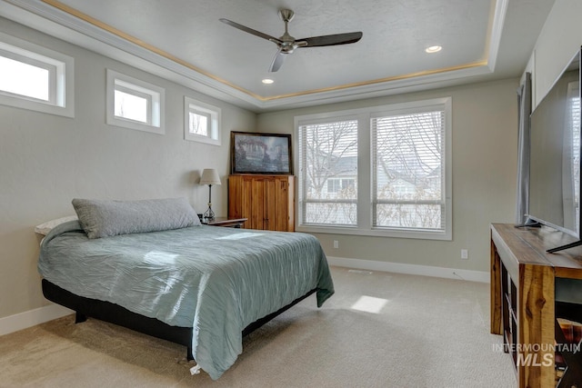 carpeted bedroom featuring baseboards, a raised ceiling, and recessed lighting