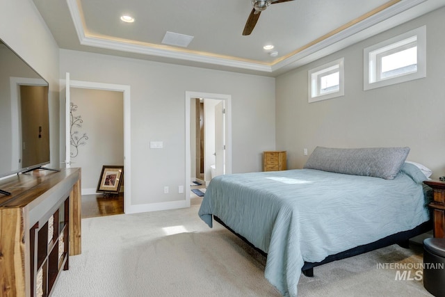 bedroom featuring recessed lighting, baseboards, a raised ceiling, and light colored carpet