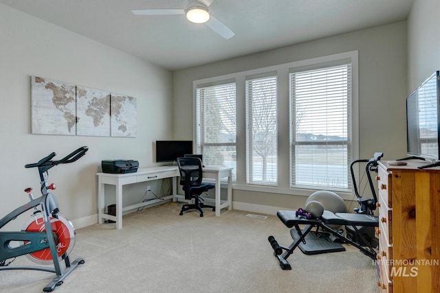 exercise room with carpet floors, baseboards, and a ceiling fan