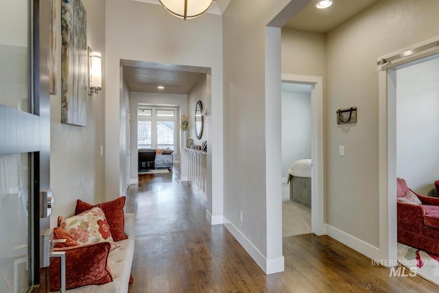 corridor with recessed lighting, baseboards, and wood finished floors