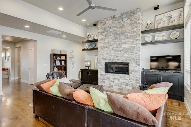 living room with a fireplace, recessed lighting, visible vents, ceiling fan, and wood finished floors