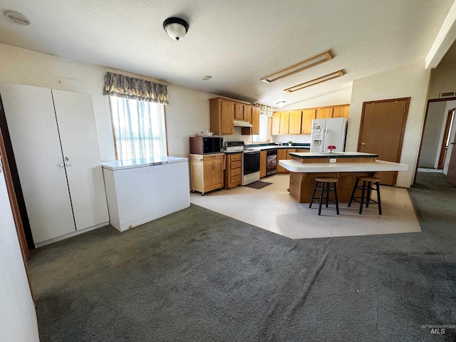 664 Lawrence Ln, Weiser, ID 83672 - kitchen with range with electric stovetop, white fridge with ice dispenser, under cabinet range hood, a kitchen island, and vaulted ceiling