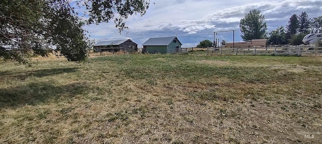 view of yard with a rural view