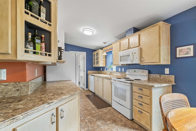 1745 Gibler Rd, Kamiah, ID 83536 - kitchen with white appliances, light brown cabinetry, a sink, glass insert cabinets, and vaulted ceiling