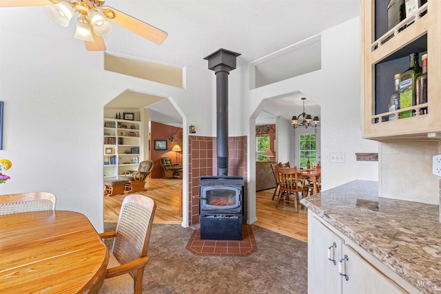 1745 Gibler Rd, Kamiah, ID 83536 - tiled dining area with a wood stove, a chandelier, arched walkways, and ceiling fan