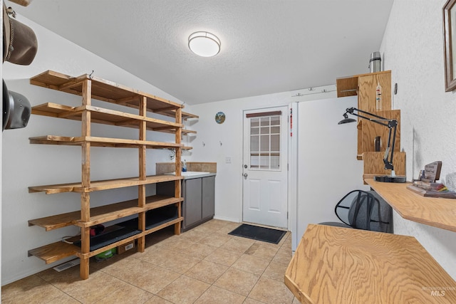 1745 Gibler Rd, Kamiah, ID 83536 - interior space featuring a textured ceiling, lofted ceiling, and light tile patterned floors