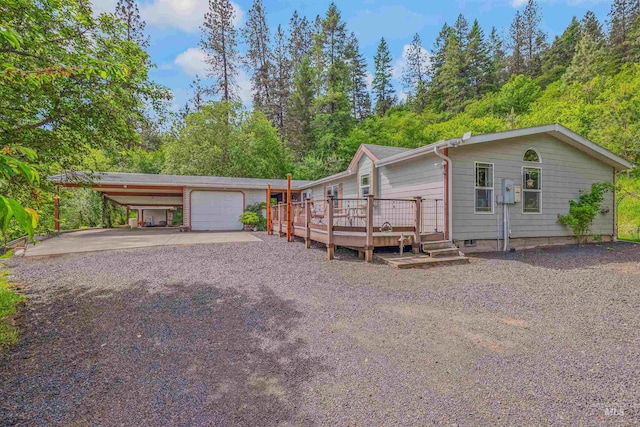 1745 Gibler Rd, Kamiah, ID 83536 - view of front of property with a carport, driveway, a wooden deck, and a garage