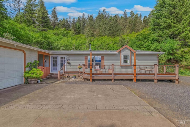1745 Gibler Rd, Kamiah, ID 83536 - view of front facade featuring a wooden deck and a forest view