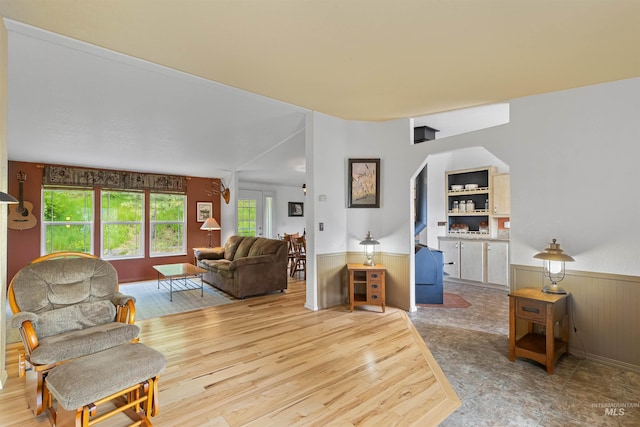 1745 Gibler Rd, Kamiah, ID 83536 - living area with arched walkways, wainscoting, wooden walls, and wood finished floors