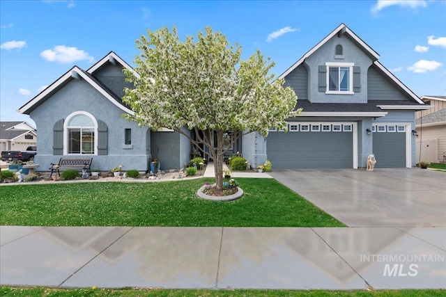 craftsman-style home featuring concrete driveway, an attached garage, stucco siding, and a front lawn
