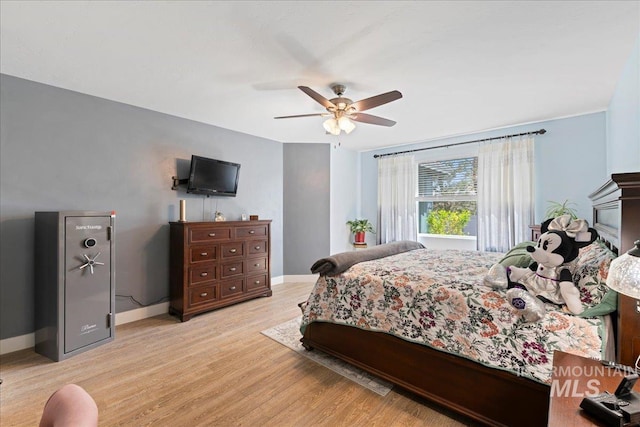 bedroom featuring baseboards, ceiling fan, and light wood-type flooring