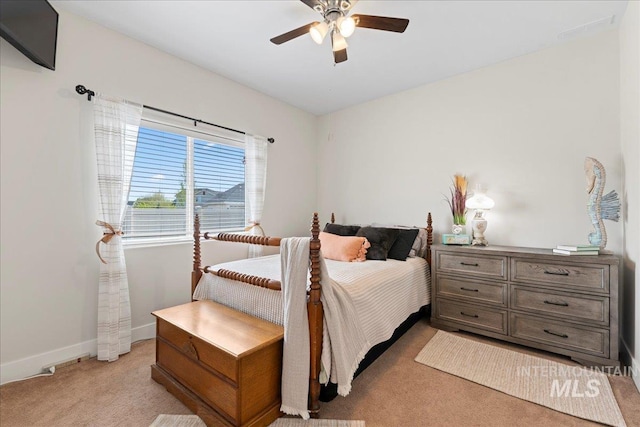 bedroom featuring a ceiling fan, baseboards, and light colored carpet