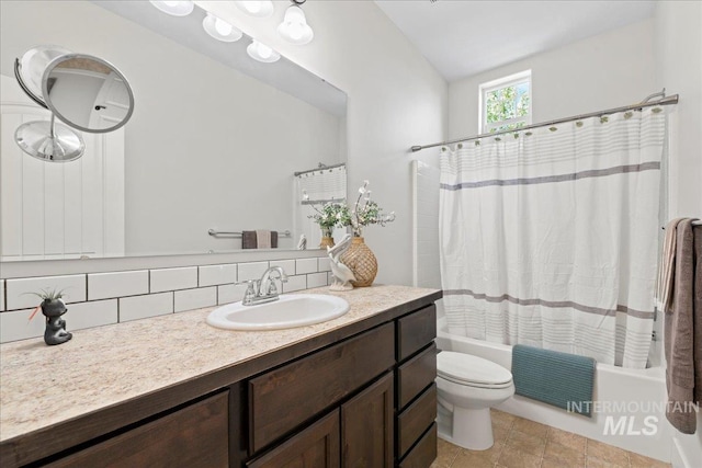 full bath featuring vanity, tasteful backsplash, toilet, and shower / tub combo with curtain