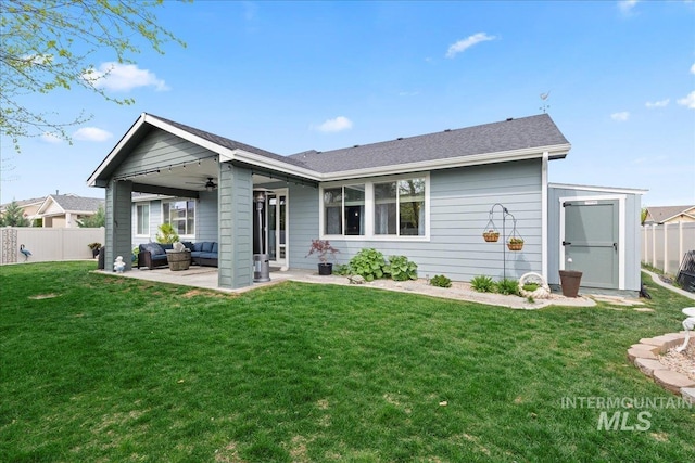 back of property featuring fence private yard, a patio, an outdoor hangout area, a ceiling fan, and a lawn