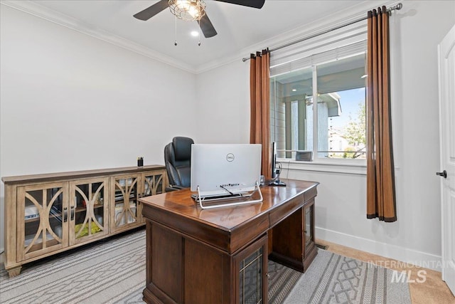 office space featuring ceiling fan, light colored carpet, ornamental molding, and baseboards