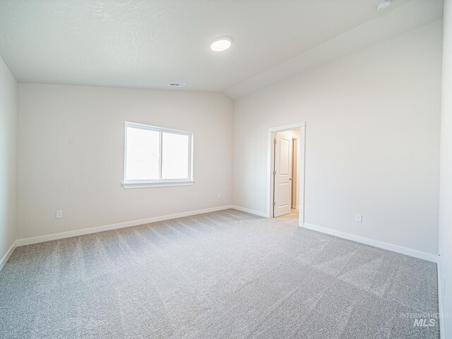 2314 E Cave Falls St, Kuna, ID 83634 - spare room featuring light colored carpet, baseboards, and lofted ceiling