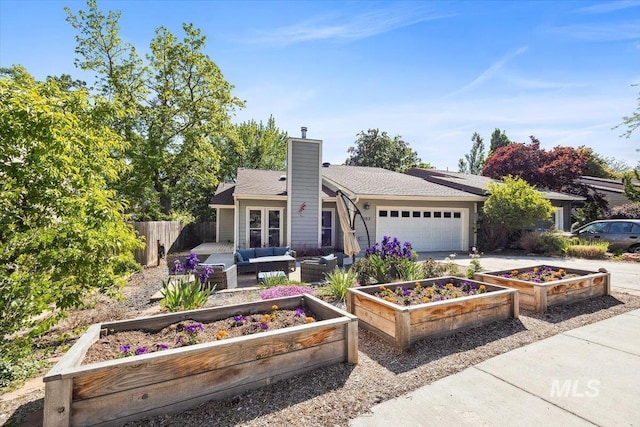 1803 E Danmor Dr, Boise, ID 83712 - view of front of property with a garden, an outdoor living space, a garage, a chimney, and concrete driveway