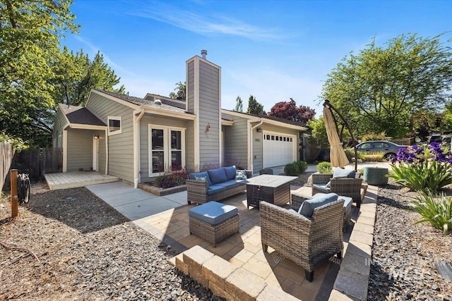 1803 E Danmor Dr, Boise, ID 83712 - back of property with a chimney, an attached garage, an outdoor hangout area, and a patio area