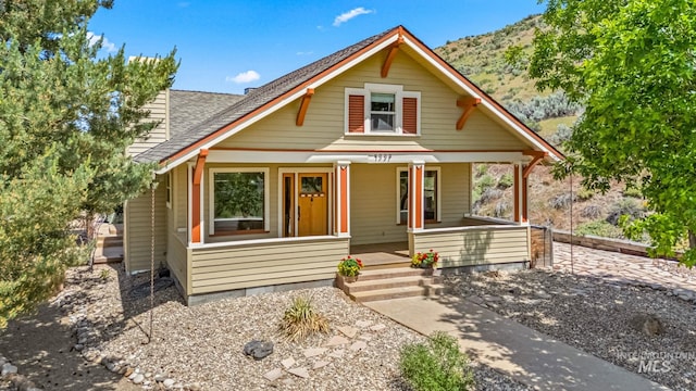 4997 N Brookside Ln, Boise, ID 83714 - bungalow-style home featuring a porch, roof with shingles, and a mountain view