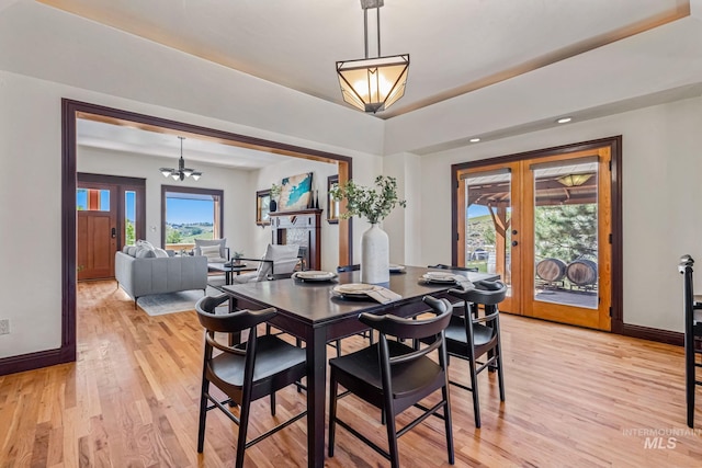 4997 N Brookside Ln, Boise, ID 83714 - dining space with french doors, light wood finished floors, baseboards, a chandelier, and recessed lighting