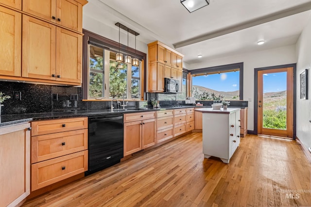 4997 N Brookside Ln, Boise, ID 83714 - kitchen with black appliances, light wood finished floors, a sink, and backsplash
