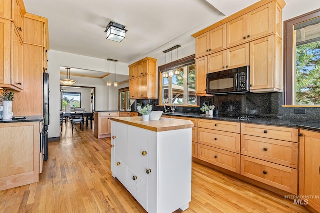 4997 N Brookside Ln, Boise, ID 83714 - kitchen with black appliances, light brown cabinetry, tasteful backsplash, light wood-style flooring, and hanging light fixtures