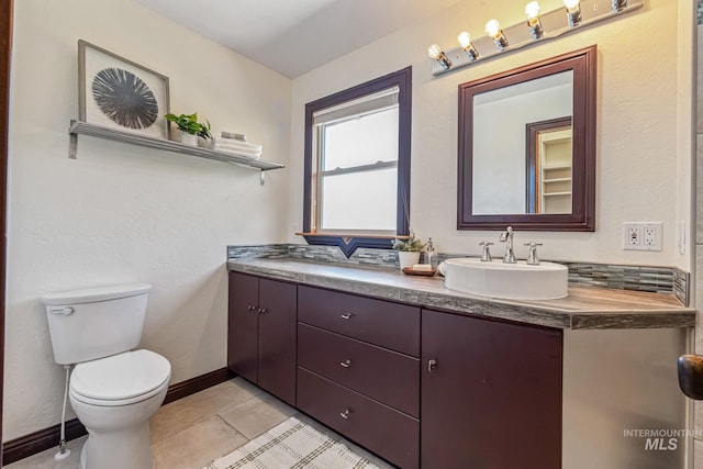 4997 N Brookside Ln, Boise, ID 83714 - full bathroom with double vanity, toilet, tile patterned flooring, and baseboards