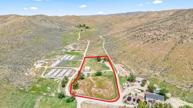 4997 N Brookside Ln, Boise, ID 83714 - aerial overview of property's location featuring property parcel outlined, a mountainous background, rural landscape, and a desert landscape