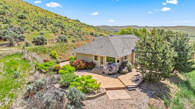 4997 N Brookside Ln, Boise, ID 83714 - back of property with a patio, a mountain view, and roof with shingles