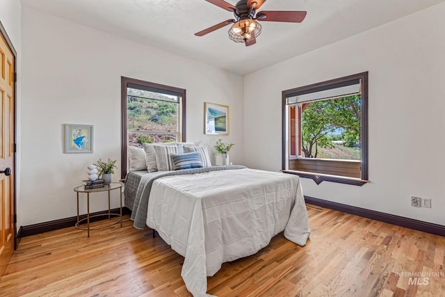 4997 N Brookside Ln, Boise, ID 83714 - bedroom with multiple windows, light wood-style floors, and baseboards