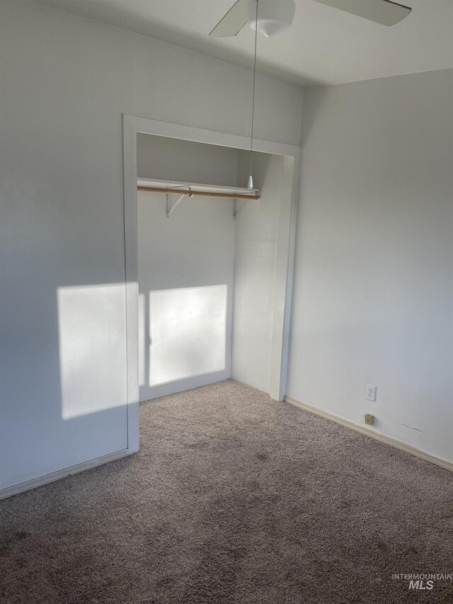 825 S 12th E, Mountain Home, ID 83647 - unfurnished bedroom featuring carpet floors and a ceiling fan