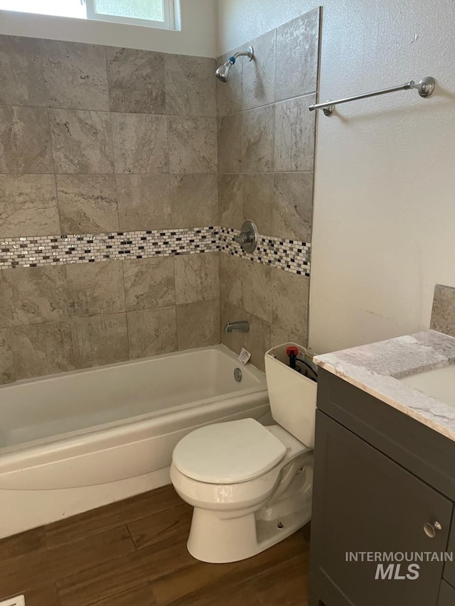 825 S 12th E, Mountain Home, ID 83647 - bathroom featuring bathing tub / shower combination, wood finished floors, vanity, and toilet