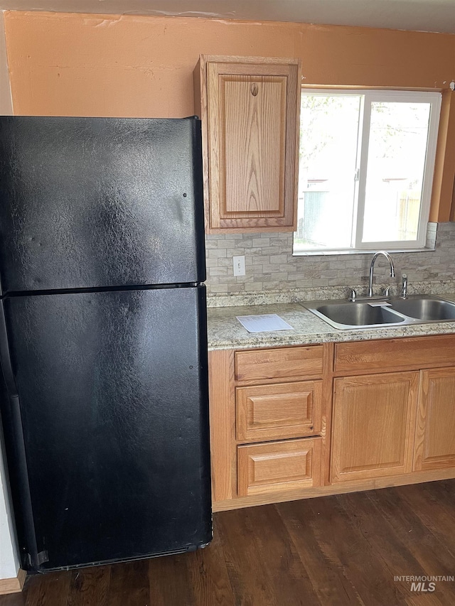 825 S 12th E, Mountain Home, ID 83647 - kitchen with freestanding refrigerator, a sink, light brown cabinets, and dark wood-style flooring
