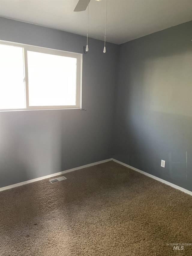825 S 12th E, Mountain Home, ID 83647 - carpeted empty room with ceiling fan and baseboards
