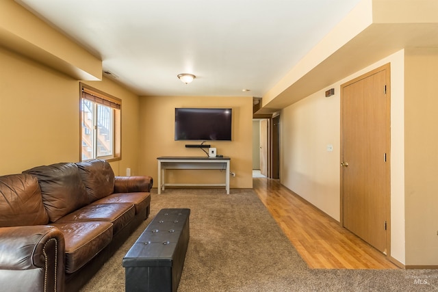 living room featuring light wood finished floors and visible vents