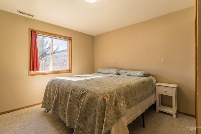 bedroom with carpet flooring, visible vents, and baseboards