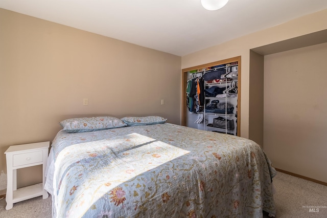 bedroom featuring a closet, baseboards, and carpet flooring