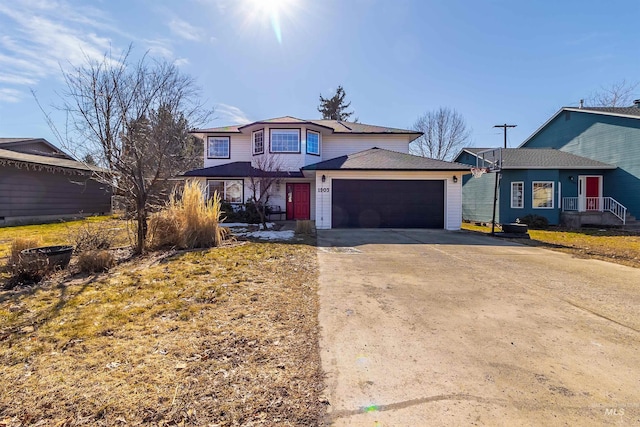 traditional home with a garage and concrete driveway