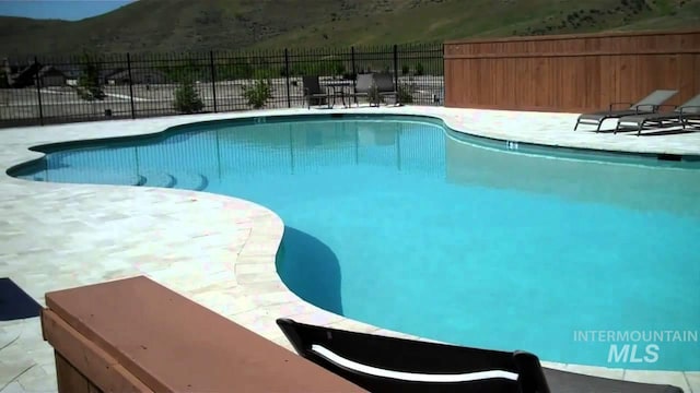 20447 N Glenisla, Boise, ID 83714 - view of swimming pool with fence, a mountain view, a fenced in pool, and a patio area