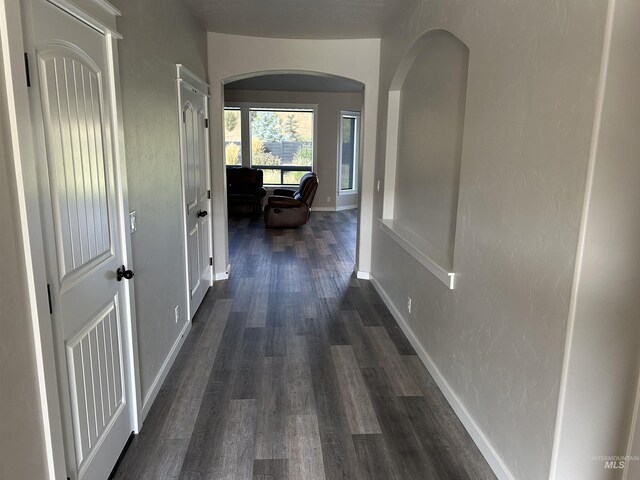 20447 N Glenisla, Boise, ID 83714 - hallway featuring arched walkways, dark wood-type flooring, and baseboards